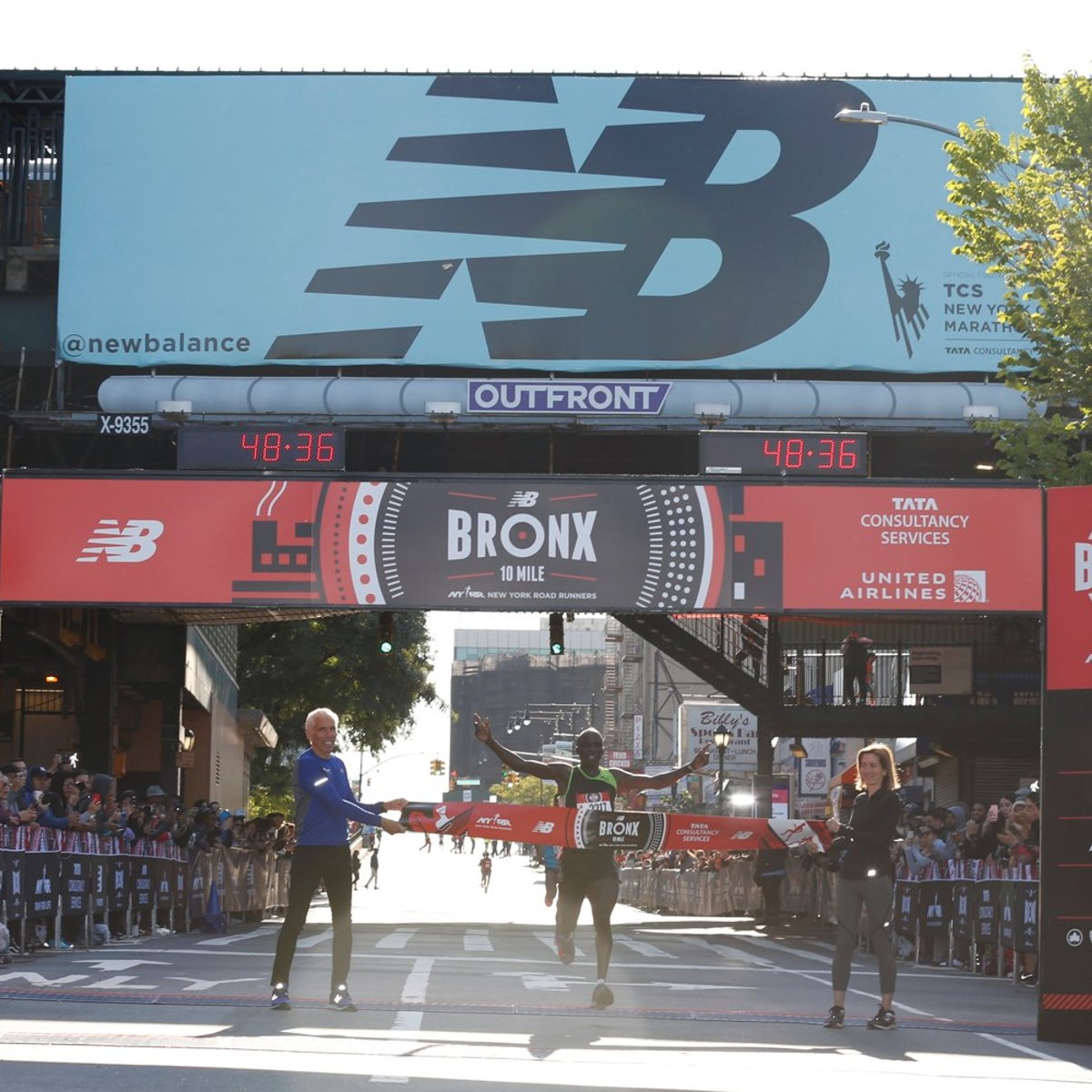 Harbert Okuti, the top men's finisher, crossing the finish line.