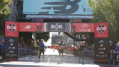Harbert Okuti, the top men's finisher, crossing the finish line.
