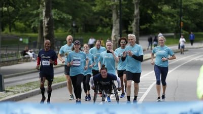 TCS New York City Marathon champions Kathrine Switzer, Tatyana McFadden and Meb Keflezighi, joined by NYRR Staff, approach the TCS New York City Marathon pop-up finish line, to finish to their NYRR Virtual Global Running Day 1M.