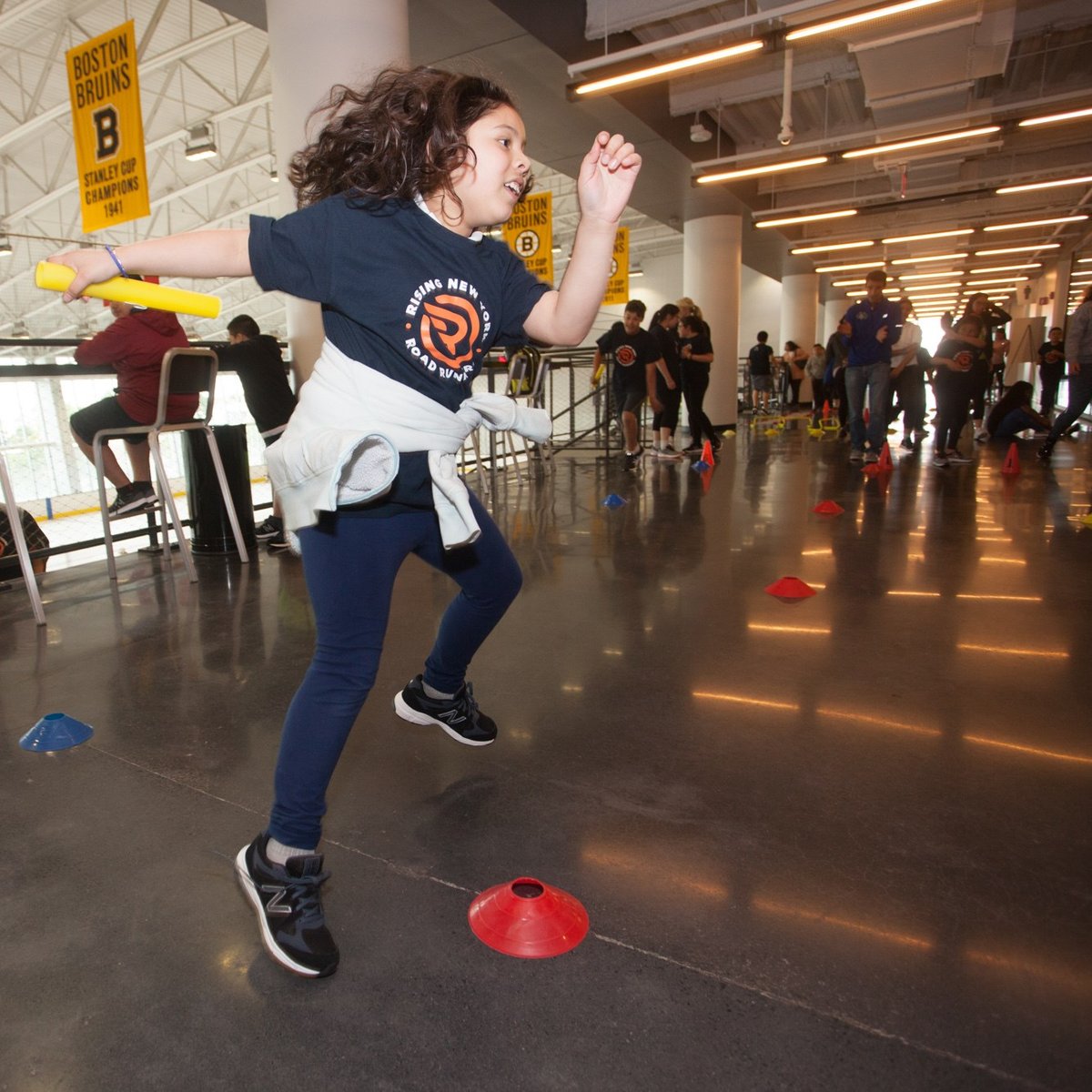 A Rising New York Road Runners participant enjoys Global Running Day activities at the Warrior Ice Arena in new New Balance shoes given as part of the 1 For You 1 For Youth program.