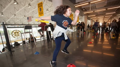 A Rising New York Road Runners participant enjoys Global Running Day activities at the Warrior Ice Arena in new New Balance shoes given as part of the 1 For You 1 For Youth program.
