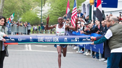 Men's first place finisher Mathew Kimeli crosses the finish line.