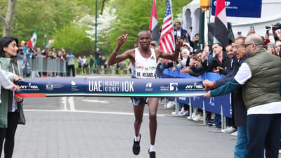 Men's first place finisher Mathew Kimeli crosses the finish line.