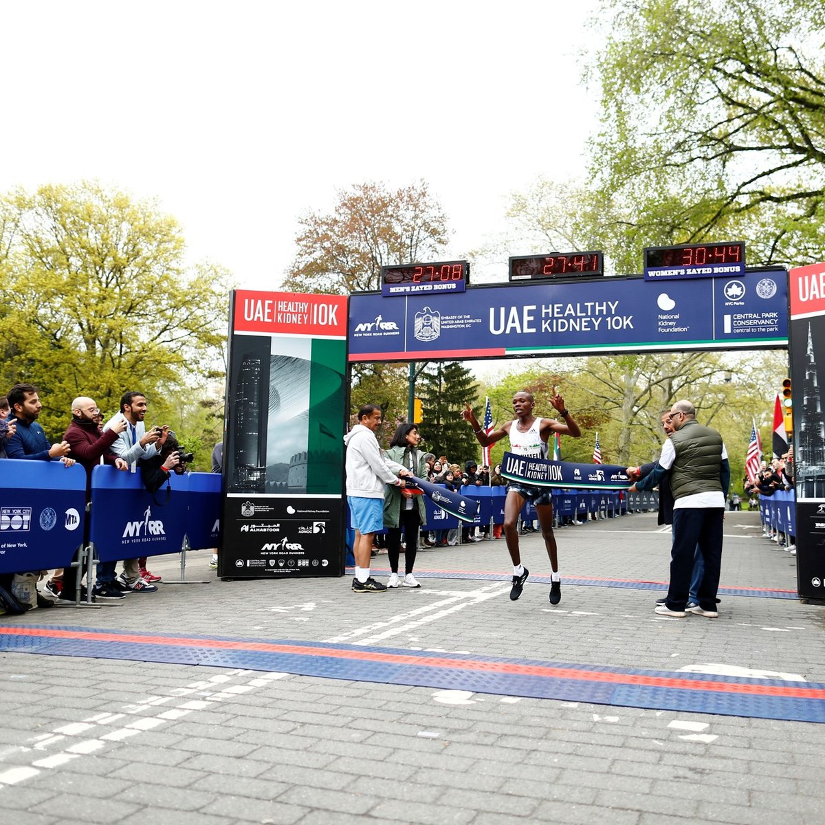Men's first place finisher Mathew Kimeli crosses the finish line.