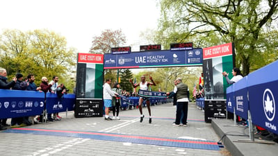 Men's first place finisher Mathew Kimeli crosses the finish line.