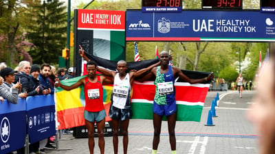 Men's first three finishers Mathew Kimeli, Girma Bekele Gebre, and Edwin Kibichiy pose with their nation's flags.