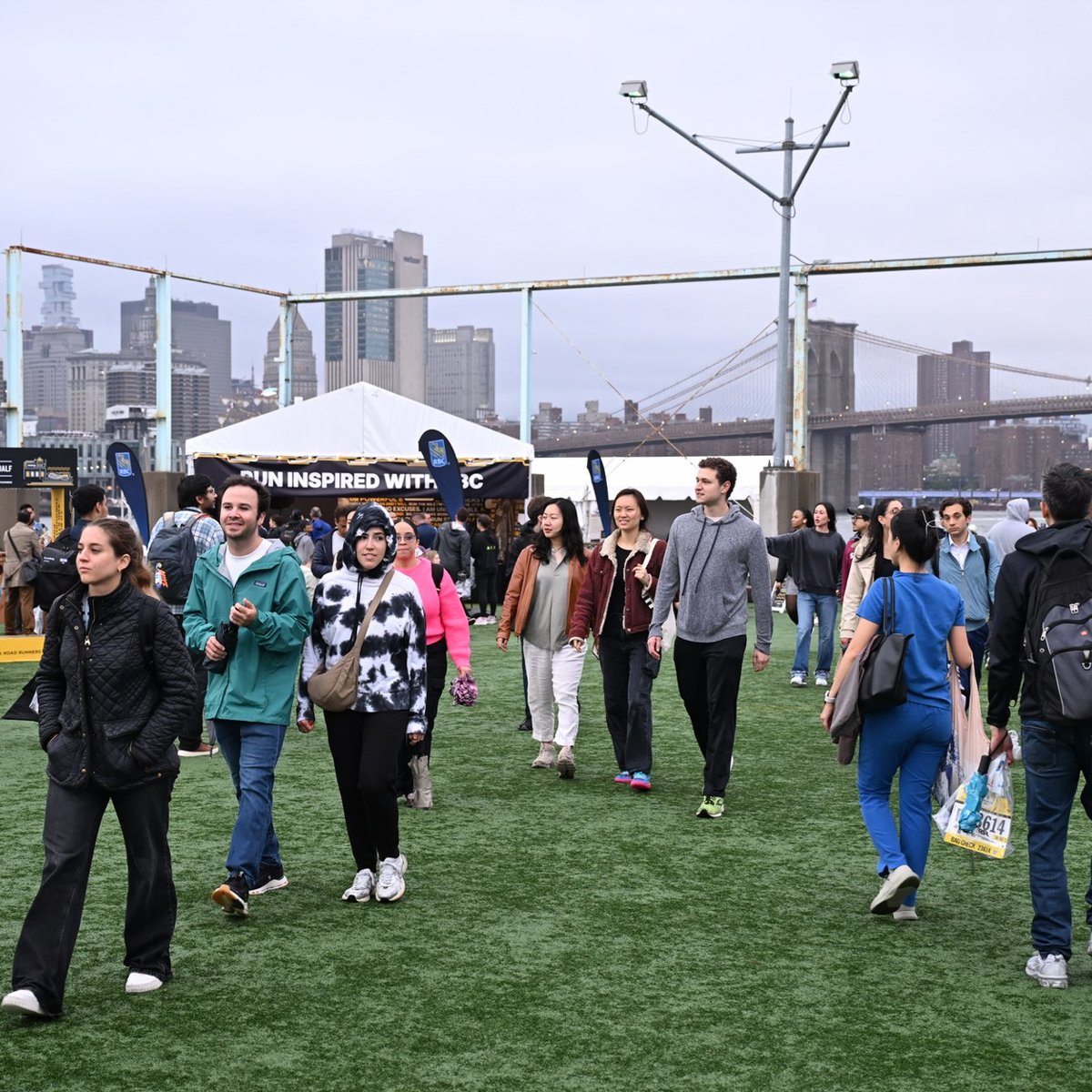 People walking around Pier 2 at the 2025 RBC Brooklyn Half Pre-Party