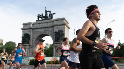 Runners run by Grand Army Plaza in Brooklyn during the RBC Brooklyn Half
