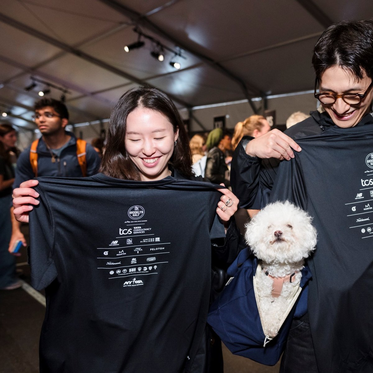 Two runners look at their RBC Brooklyn Half t-shirts at the 2025 RBC Brooklyn Half Pre-Party