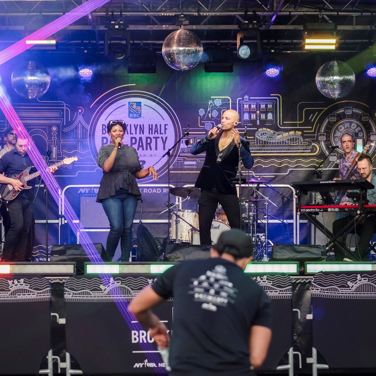 Two singers perform on stage at the 2025 RBC Brooklyn Half Pre-Party