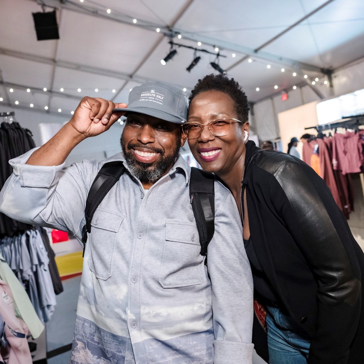 Two people smile for a photo in the New Balance store at the 2025 RBC Brooklyn Half Pre-Party