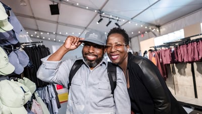 Two people smile for a photo in the New Balance store at the 2025 RBC Brooklyn Half Pre-Party