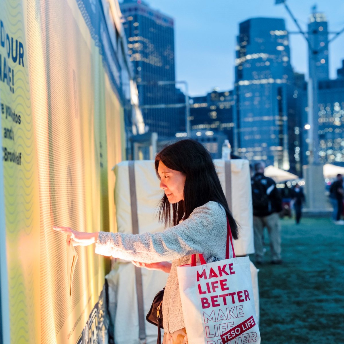 A woman searches for her name on the name wall at the 2025 RBC Brooklyn Half Pre-Party