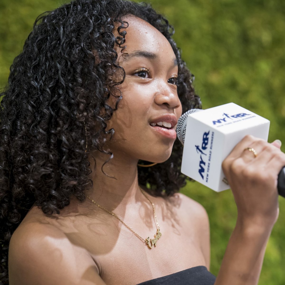 A youth ambassador speaks into a mic