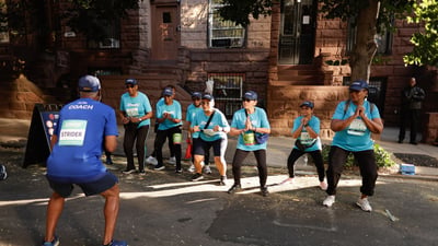 Harlem 5K participants with coach