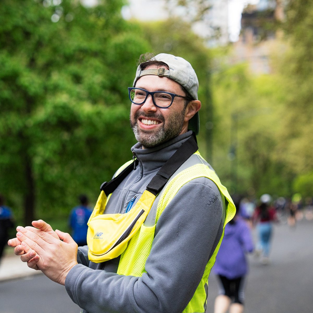 Volunteer cheering on runners in Central Park