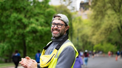 Volunteer cheering on runners in Central Park