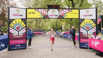 Runner breaks tape at the Maybelline Women's Half in Central Park