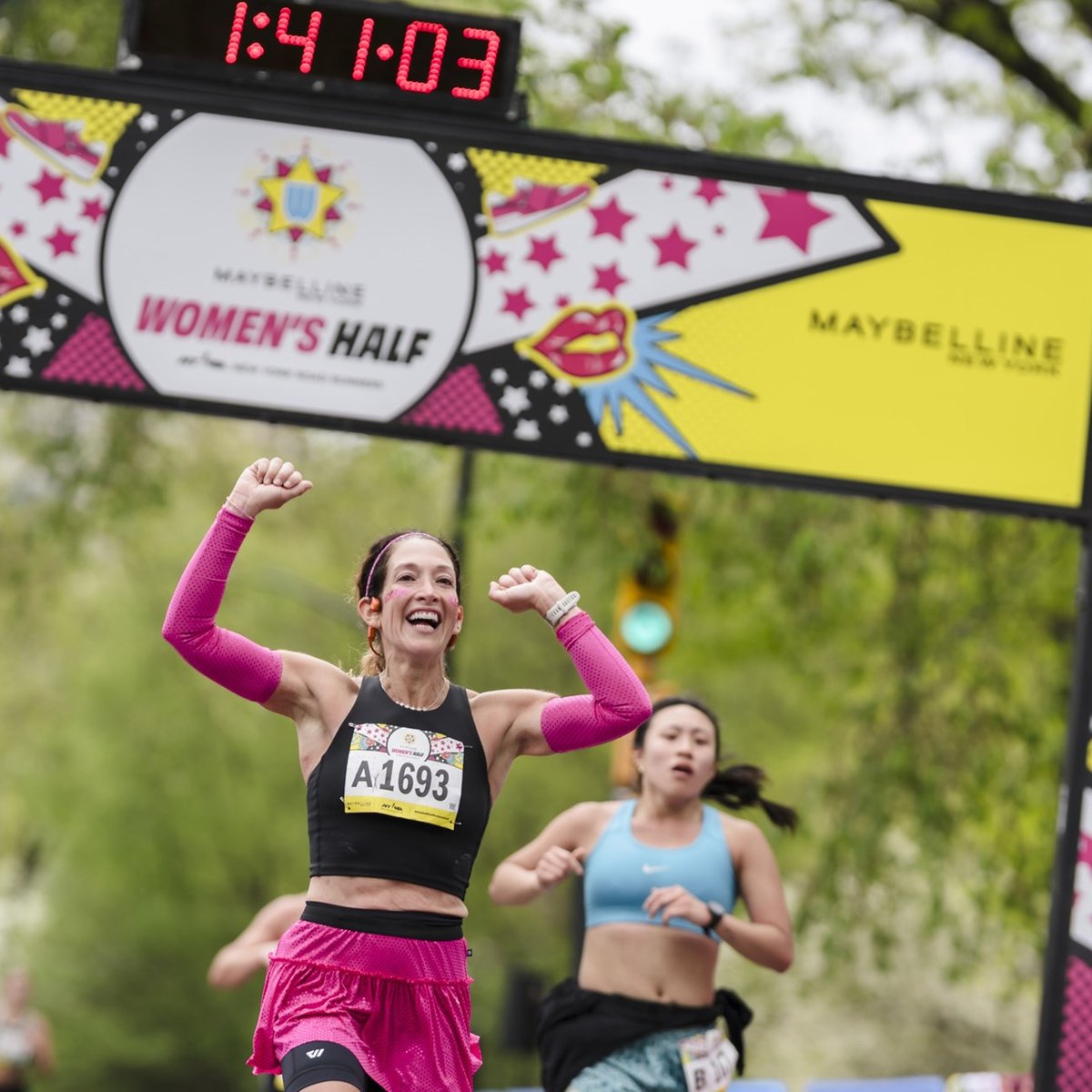 Runners cross the finish line at the Maybelline Women's Half in Central Park
