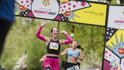 Runners cross the finish line at the Maybelline Women's Half in Central Park