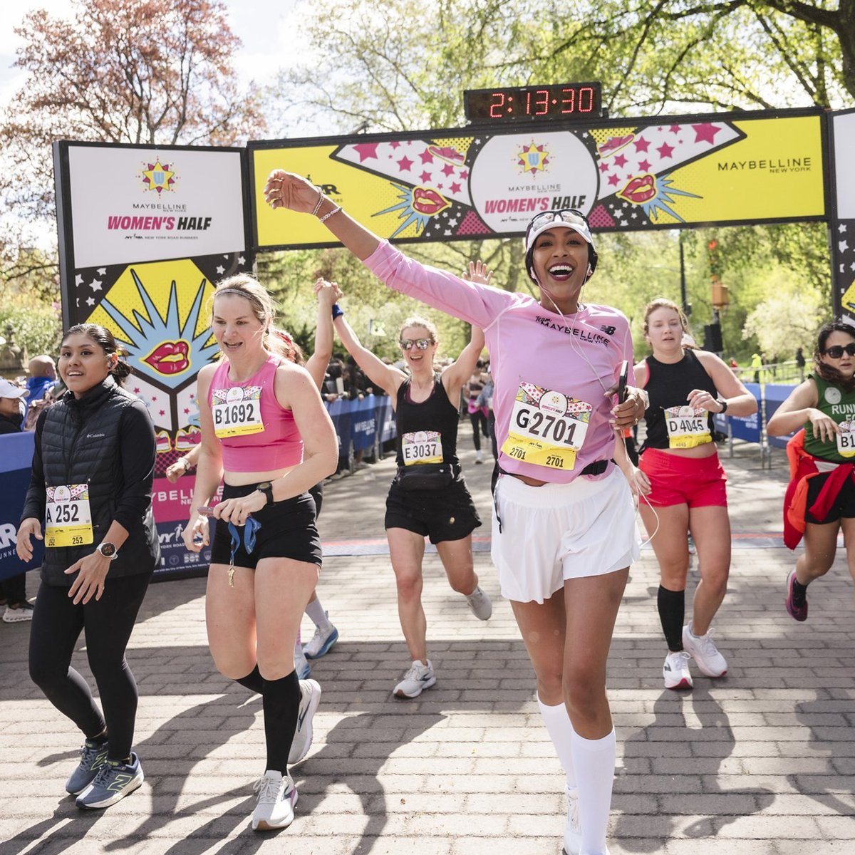 Runners cross the finish line at the Maybelline Women's Half in Central Park