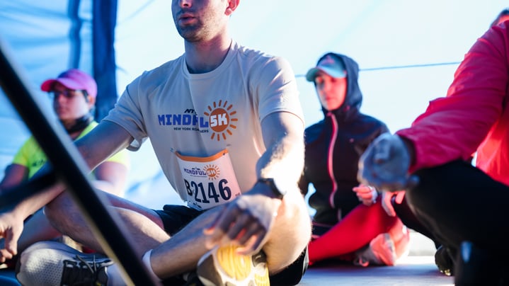 Participants do yoga with their eyes closed and legs crossed