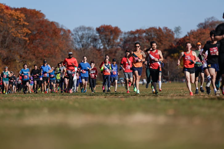 Cross country runners with hill in distance at NYRR race in Van Cortlandt Park on November 19 2023