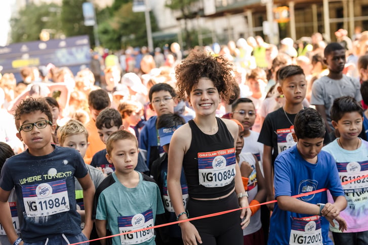 Kids at start line of 2024 Back to School Mile at NB 5th Ave Mile