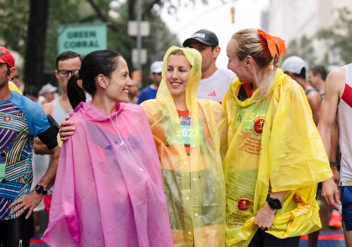 Runners with rain ponchos at the New Balance 5th Avenue Mile course