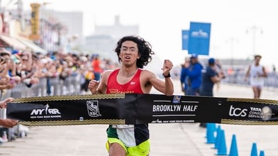Galo Vasquez crosses the RBC Brooklyn Half finish line in first place as top nonbinary runner.