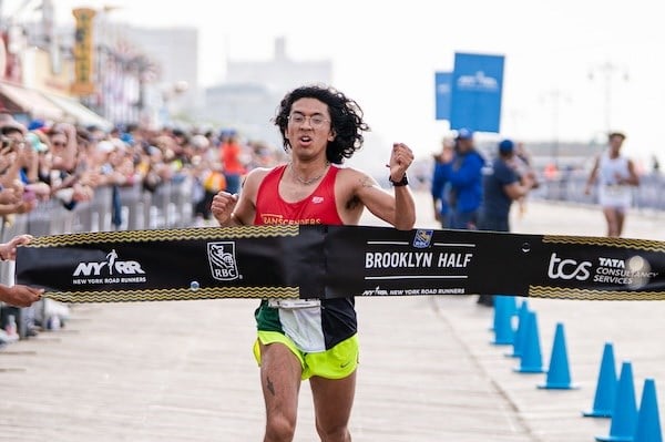 Galo Vasquez crosses the RBC Brooklyn Half finish line in first place as top nonbinary runner.