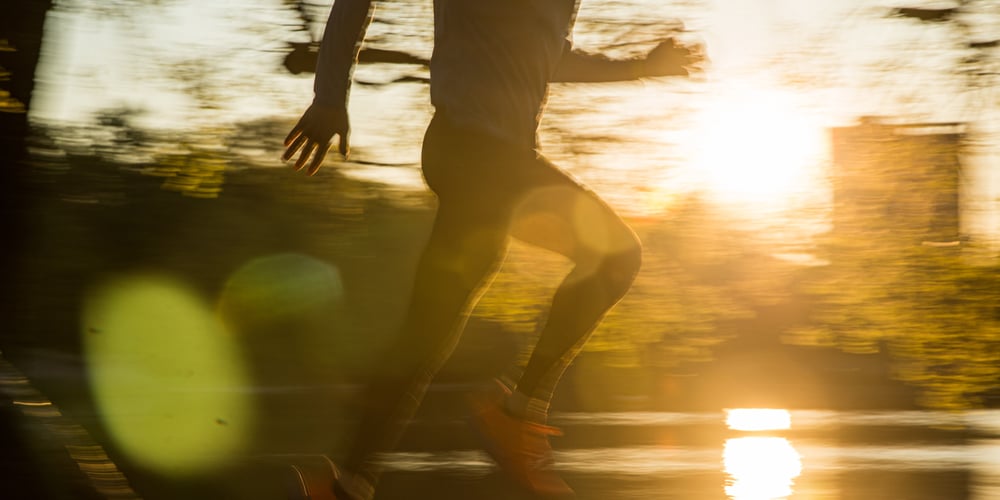 Runner silhouette with sunset and water backdrop
