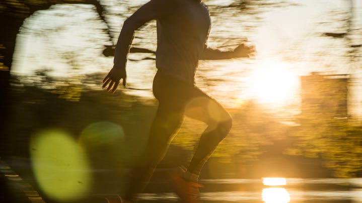 Runner silhouette with sunset and water backdrop