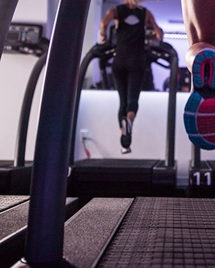 Photo of peoples legs while they run on treadmills