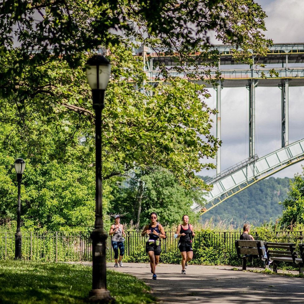A runner in Jersey City with the Colgate Clock and the Lower Manhattan skyline in the background
