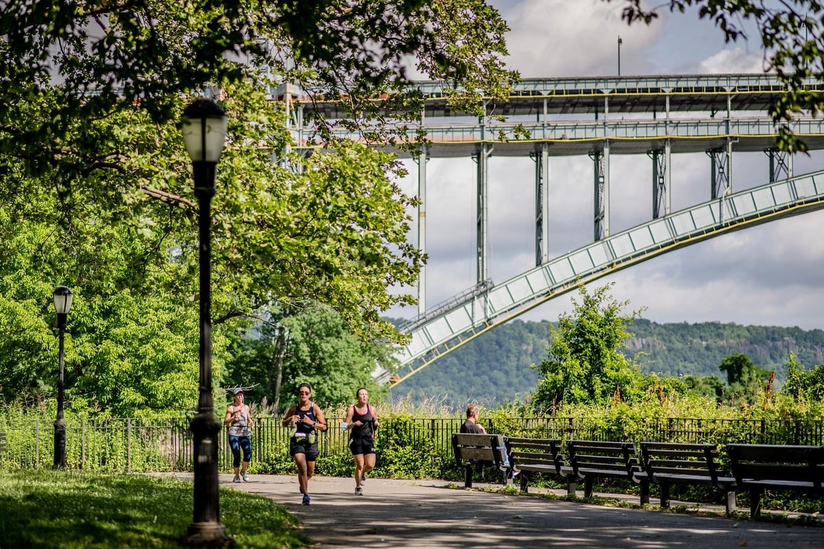 A runner in Jersey City with the Colgate Clock and the Lower Manhattan skyline in the background