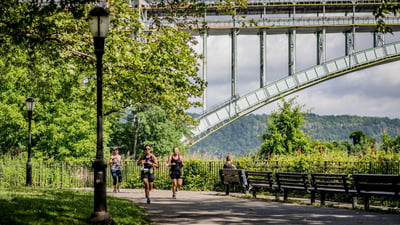 A runner in Jersey City with the Colgate Clock and the Lower Manhattan skyline in the background
