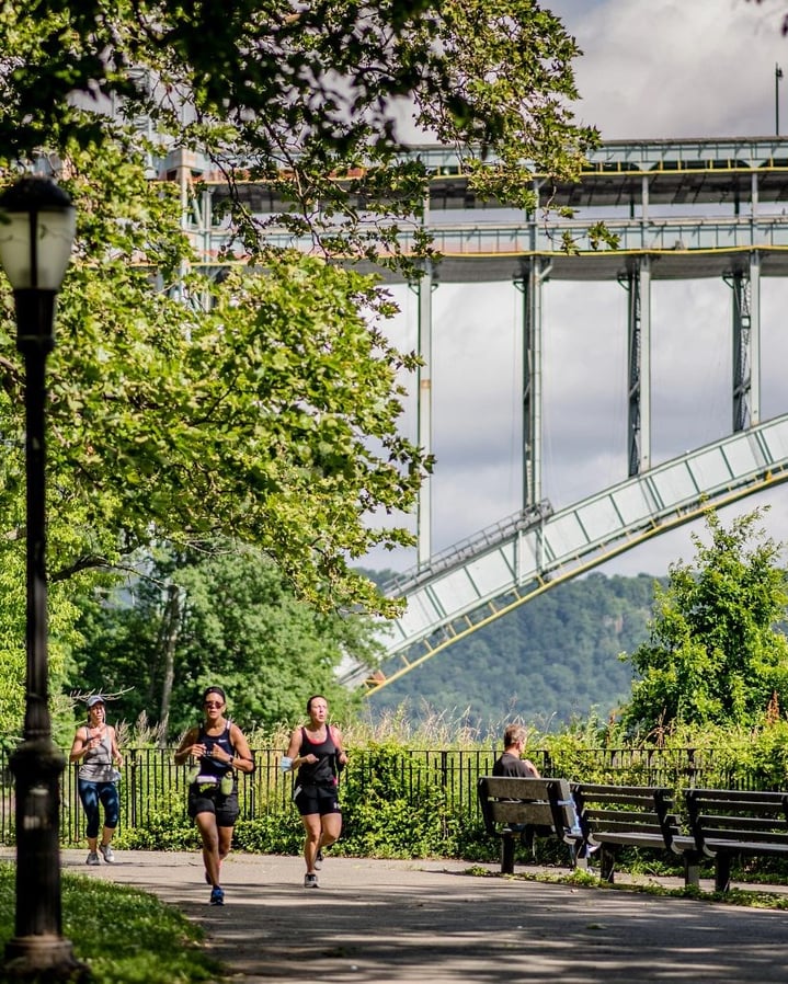 A runner in Jersey City with the Colgate Clock and the Lower Manhattan skyline in the background
