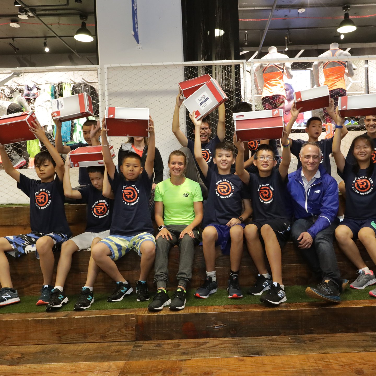 Kids raising their free shoes in the air at the Run Center