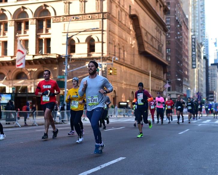 Runners in the United Airlines NYC Half passing Carnegie Hall on Seventh Avenue
