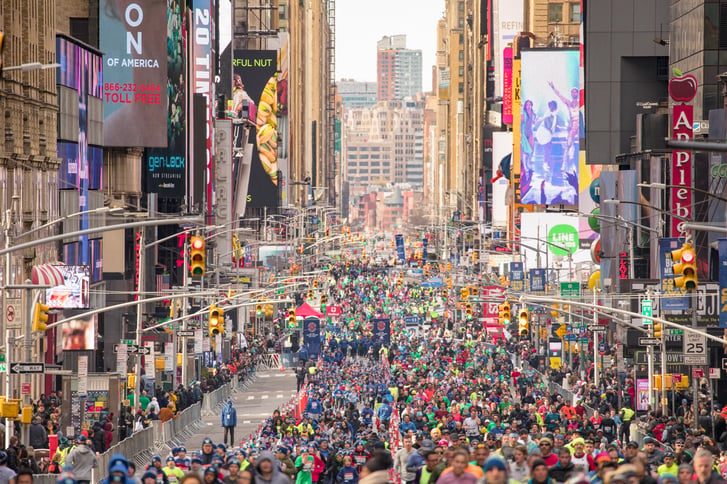 Runners running up Seventh Avenue through Times Square