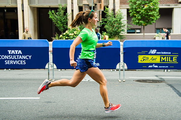 Woman running 2019 Fifth Ave Mile