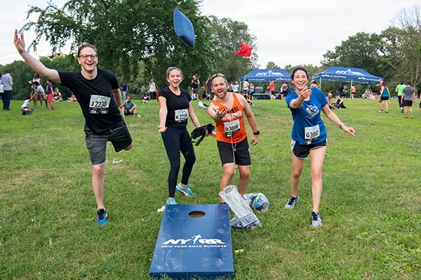 Four runners playing games at 2019 Brooklyn RUN 5K festival