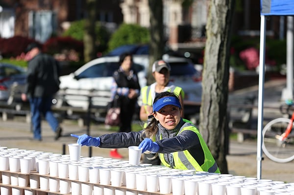 Volunteer handing out water at 2019 Brooklyn Half