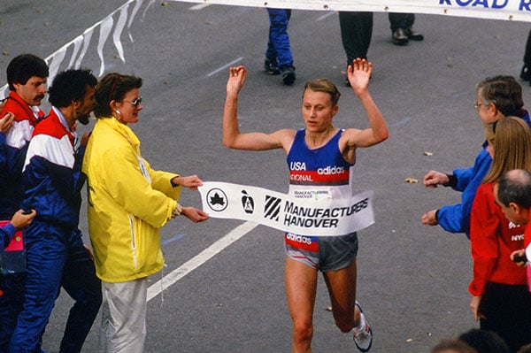 Grete Waitz breaking tape at NYC Marathon