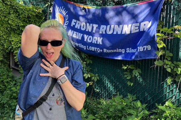 Jordan Bailey Dinwiddie standing in front of FRNY banner