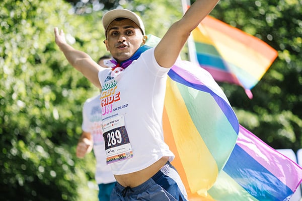 Runner with flag at 2021 FRNY LGBT Pride Run