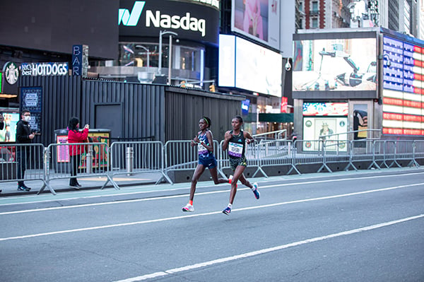 Two pro runners in Times Square at 2022 UA NYC Half