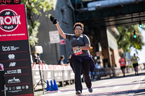 Runner crossing the finish line at the New Balance Bronx 10 Mile.