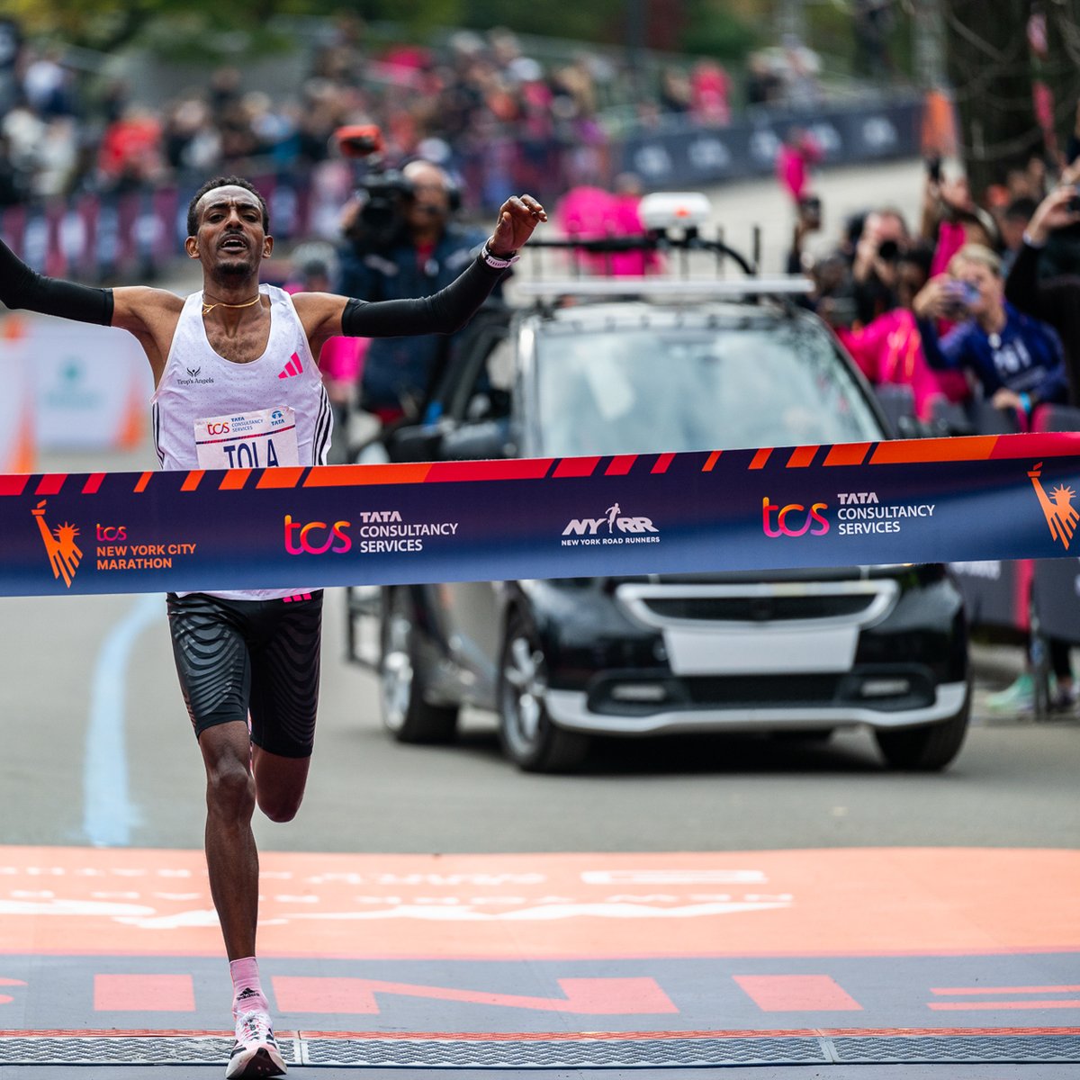 Tamira Tola breaking tape at 2023 TCS NYC Marathon.
